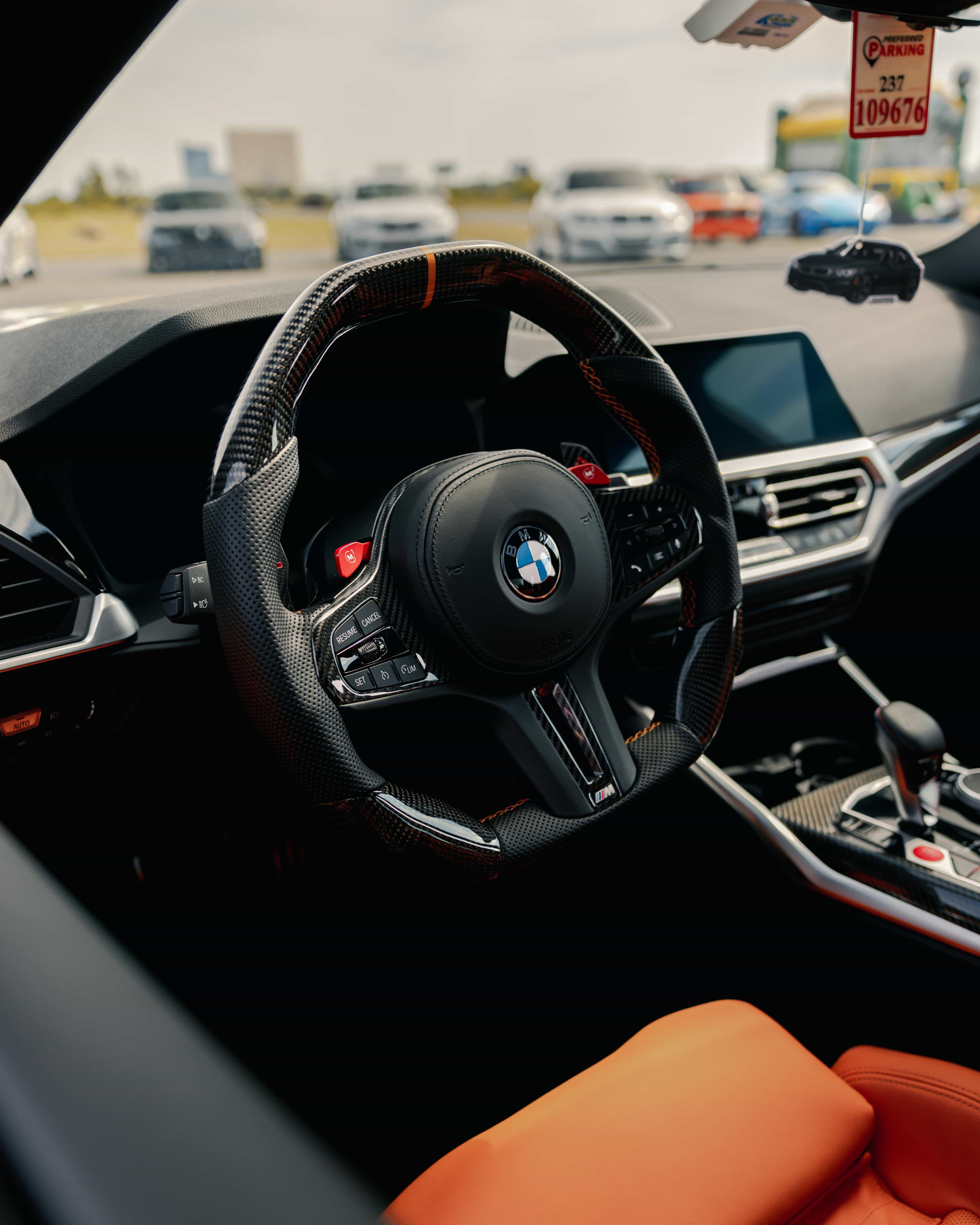 2026 BMW M cockpit – carbon trim, thick M steering wheel, low-slung seats, driver-focused layout – precision engineering inside